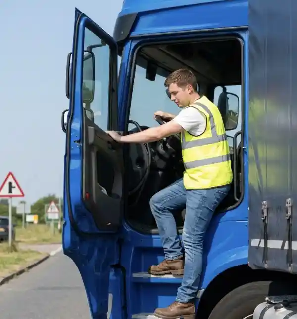 HGV driver checking vehicle compliance before departing a Cambridge depot