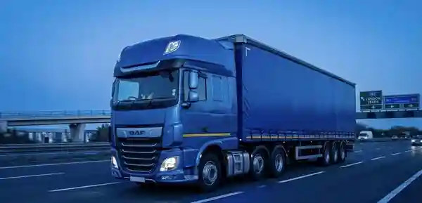 Logistics driver loading delivery van at a UK depot